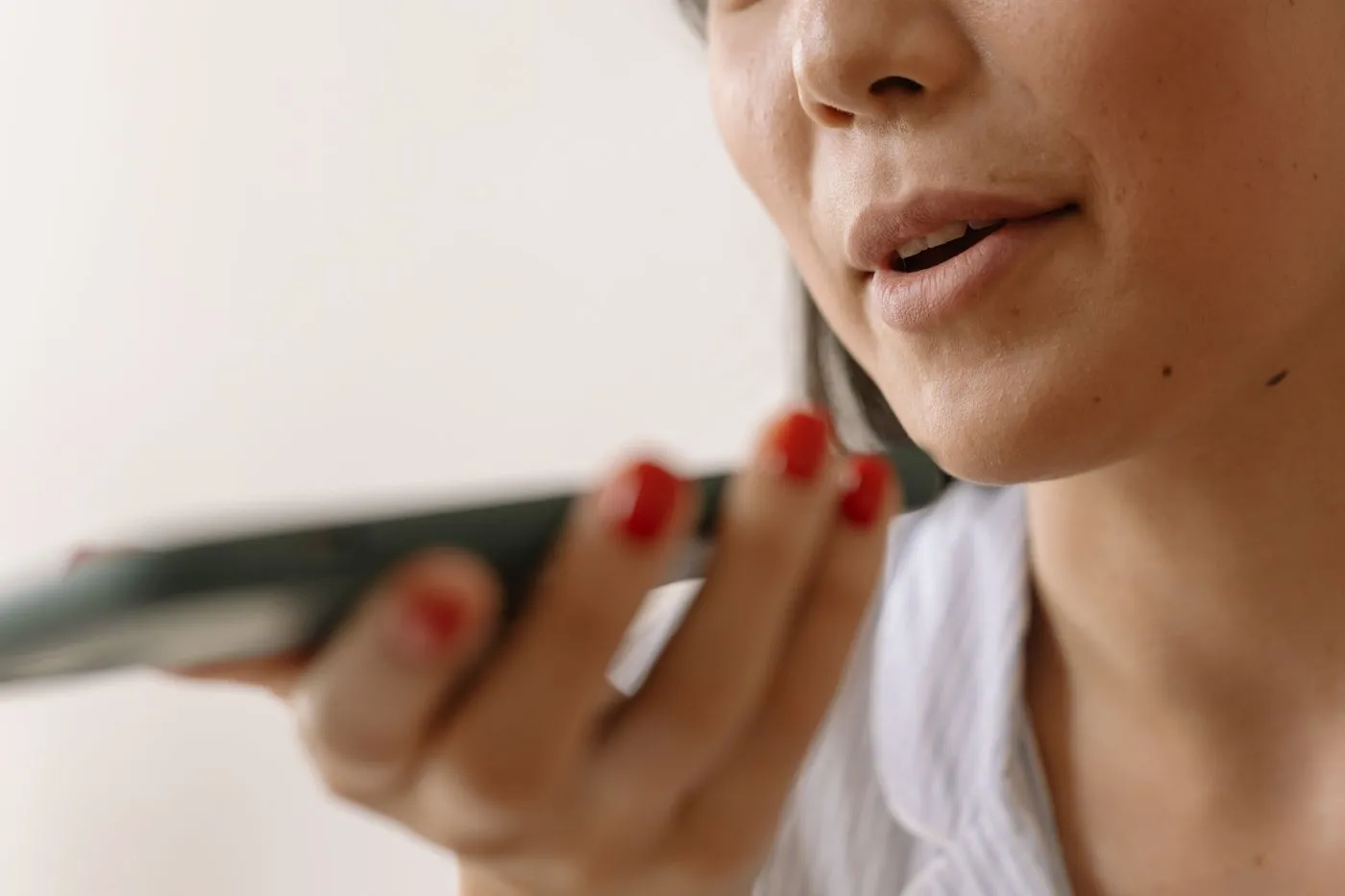 A woman speaking a question into her smartphone